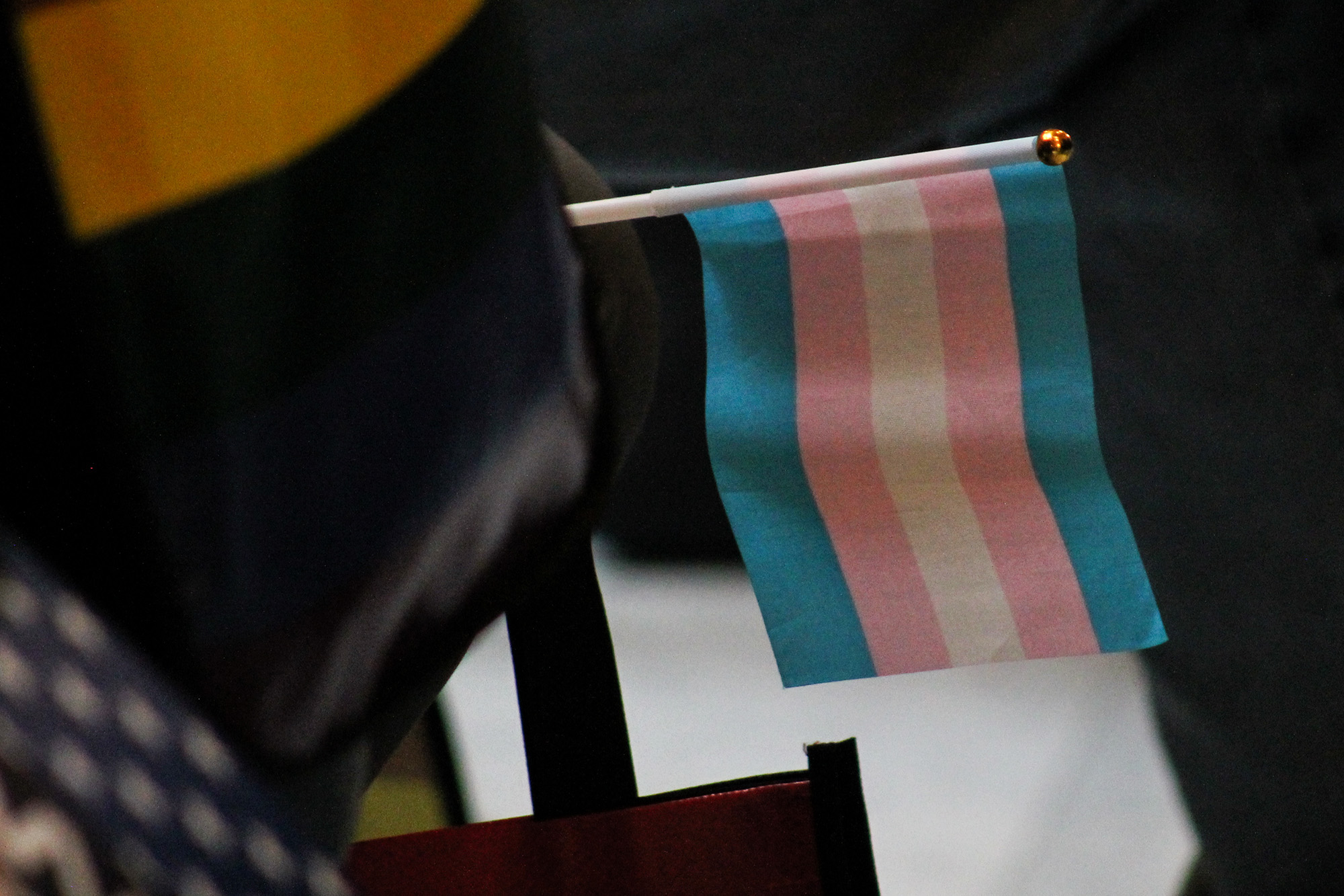A transgender pride flag is wedged into a chair at the Indiana Statehouse.